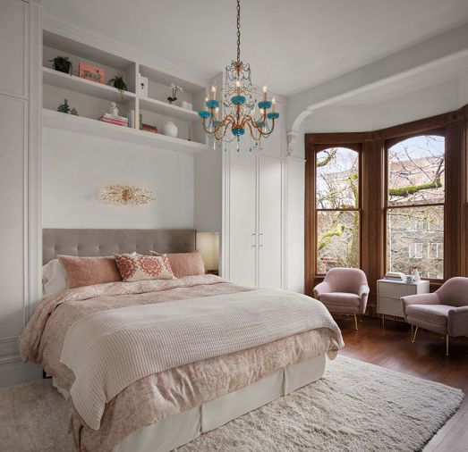 Hill designed a built-in bed nook that includes shelving, and his and her closets on either side Hill designed a built-in bed nook that includes shelving, and his and her closets on either side