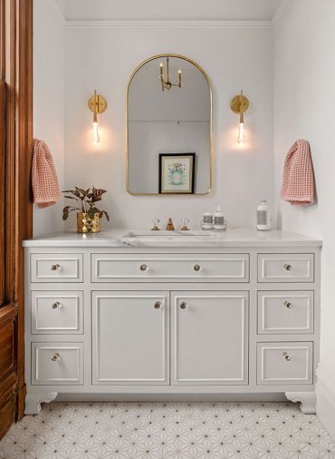 The primary bath includes a gorgeous custom vanity with marble top and marble and brass decorative flooring The primary bath includes a gorgeous custom vanity with marble top and marble and brass decorative flooring