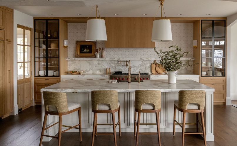 The light and airy kitchen includes glass-front cabinetry by Beech Tree Woodworks, Calacatta Gold marble counters and backsplash, and Tabarka Studios wall tile from Statements Tile & Stone Showroom create an open feel that pulls occupants in The light and airy kitchen includes glass-front cabinetry by Beech Tree Woodworks, Calacatta Gold marble counters and backsplash, and Tabarka Studios wall tile from Statements Tile & Stone Showroom create an open feel that pulls occupants in