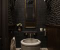 The powder room offers intensity and drama, with its textured wallpaper from Jennifer West Showroom and unique sconces from Visual Comfort The powder room offers intensity and drama, with its textured wallpaper from Jennifer West Showroom and unique sconces from Visual Comfort