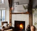 Guests can cozy up on a Manor Fine Wares armchair alongside the glistening Zellige Ann Sacks tiled fireplace, its mantel and surround crafted from wood felled on the property. Guests can cozy up on a Manor Fine Wares armchair alongside the glistening Zellige Ann Sacks tiled fireplace, its mantel and surround crafted from wood felled on the property.