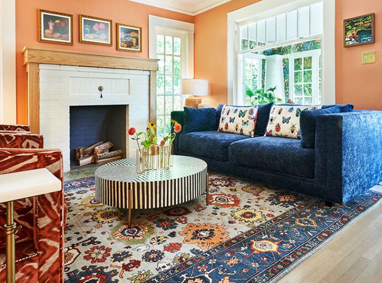 Happy, rich colors enrobe the living room’s walls and furnishings revolving around a multicolored rug. Happy, rich colors enrobe the living room’s walls and furnishings revolving around a multicolored rug.