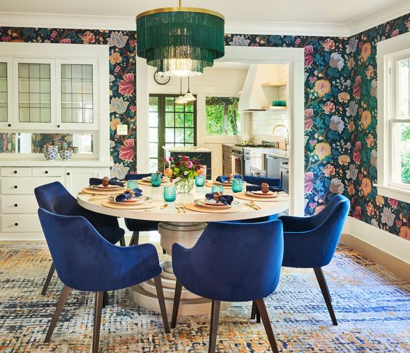 Florals found in Cole & Son “Midsummer Bloom” wallpaper encircle the dining experience crowned by a fabulous Regina Andrew Cabaret Fringe chandelier, circular CFC Liz dining table and voluptuous velour chairs. Florals found in Cole & Son “Midsummer Bloom” wallpaper encircle the dining experience crowned by a fabulous Regina Andrew Cabaret Fringe chandelier, circular CFC Liz dining table and voluptuous velour chairs.