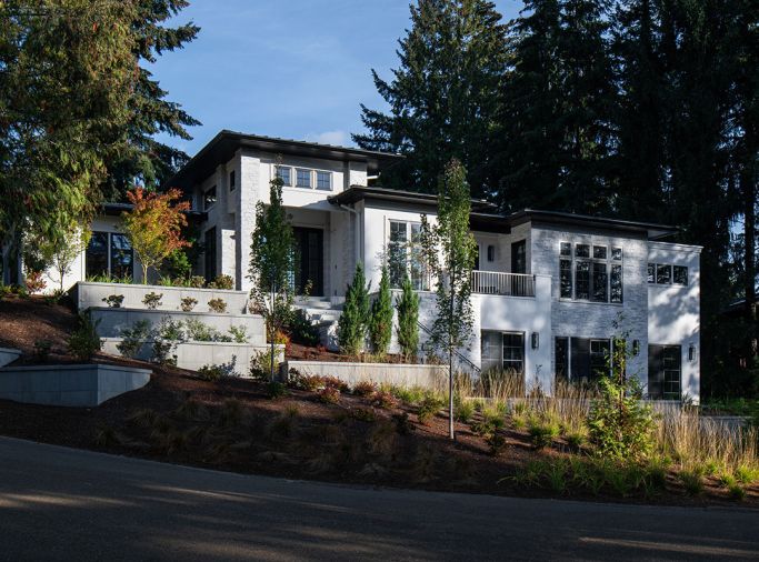 The exterior is painted in Sherwin Williams “Snowbound” with trim in “Tricorn Black,” and paired with white masonry accents. A black roof and ample windows create the rest of the look. The exterior is painted in Sherwin Williams “Snowbound” with trim in “Tricorn Black,” and paired with white masonry accents. A black roof and ample windows create the rest of the look.