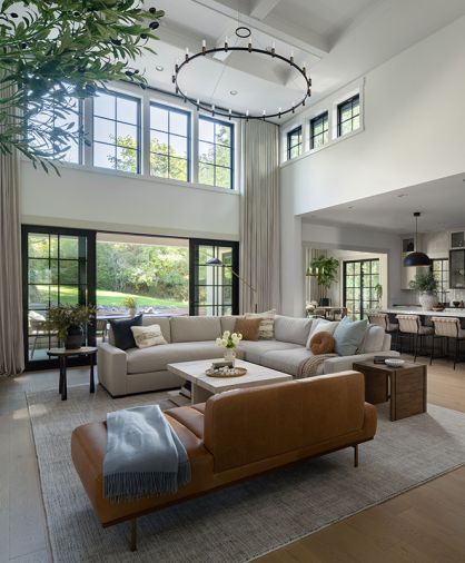 Four Hands side tables from J Garner Home flank the Restoration Hardware sectional. A leather sofa from Interior Define is an artful spot to lounge or seat guests. Four Hands side tables from J Garner Home flank the Restoration Hardware sectional. A leather sofa from Interior Define is an artful spot to lounge or seat guests.