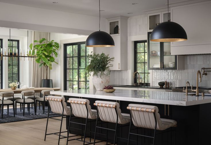 Finishes include brushed oak floors and a porcelain island counter, joined with white leather counter stools from Denver Modern. Bedrosians Cloe tile and Eglo pendant lights bring sheen to the kitchen. Finishes include brushed oak floors and a porcelain island counter, joined with white leather counter stools from Denver Modern. Bedrosians Cloe tile and Eglo pendant lights bring sheen to the kitchen.