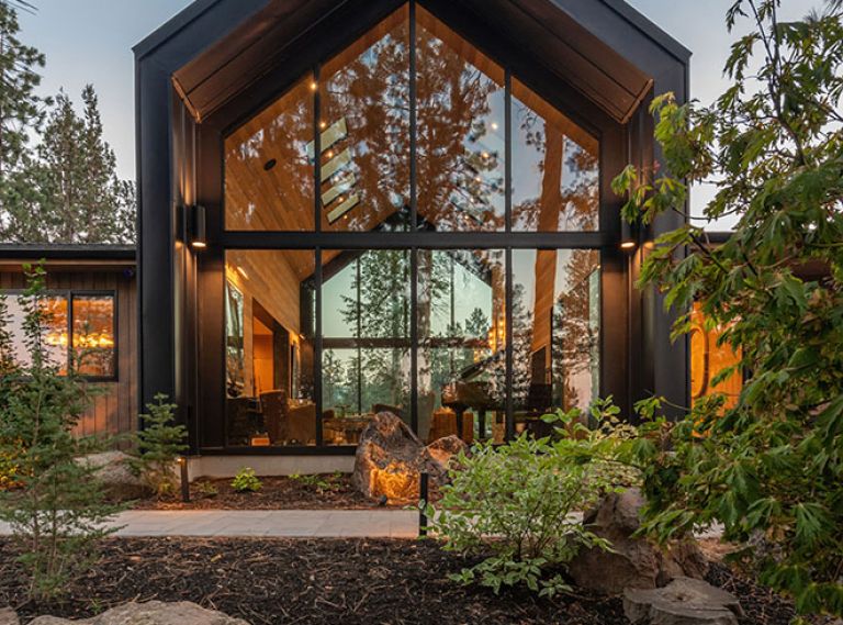 For the front facade, Island Sash & Door installed Weathershield windows and doors. The A-frame section, majestic in stature, is then wrapped in a metal roof and siding, adding weather protection from the harsh Central Oregon climate. For the front facade, Island Sash & Door installed Weathershield windows and doors. The A-frame section, majestic in stature, is then wrapped in a metal roof and siding, adding weather protection from the harsh Central Oregon climate.