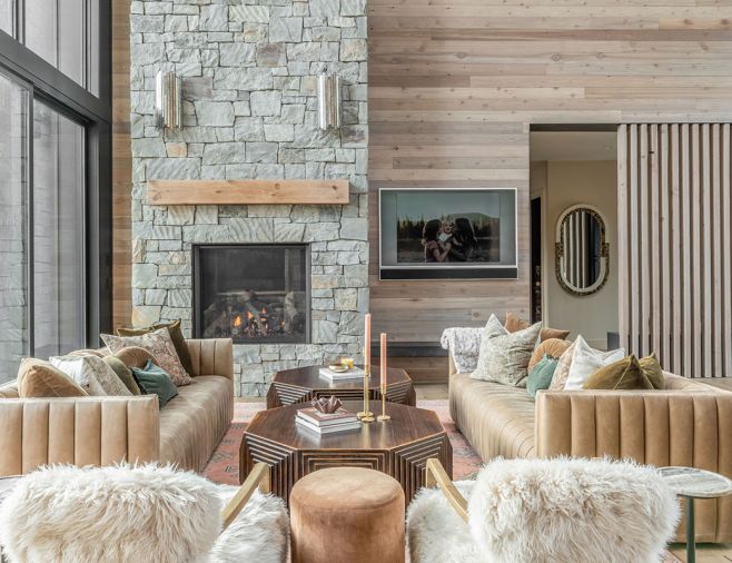 The Art Deco vibe is carried throughout the great room with bold Arhaus coffee tables flanked by Four Hands leather sofas and wall paneling to mirror the exterior siding. The Art Deco vibe is carried throughout the great room with bold Arhaus coffee tables flanked by Four Hands leather sofas and wall paneling to mirror the exterior siding.