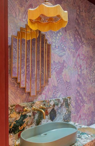 The powder room features the “Aflutter” butterfly wing design, printed on a beautiful textured paper wallcovering by Phillip Jeffries. Added room elements include a 1920's inspired mirror, a complementary slope-sink, and custom pendant light. The powder room features the “Aflutter” butterfly wing design, printed on a beautiful textured paper wallcovering by Phillip Jeffries. Added room elements include a 1920's inspired mirror, a complementary slope-sink, and custom pendant light.