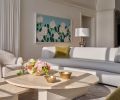 Highlighting the homeowner’s extensive art collection, including the Alex Katz artwork titled “White Roses”, are Isla coffee tables and a curved sofa from Dmitriy & Co in neutral tones. Highlighting the homeowner’s extensive art collection, including the Alex Katz artwork titled “White Roses”, are Isla coffee tables and a curved sofa from Dmitriy & Co in neutral tones.