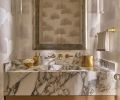 Guests are greeted with a stellar jewel box powder room whose dreamy aspects include a Calacatta Viola marble sink by Lambert Stoneworks, with ceruse finish cabinet by O.B. Williams and Morgans Fine Finishes. Guests are greeted with a stellar jewel box powder room whose dreamy aspects include a Calacatta Viola marble sink by Lambert Stoneworks, with ceruse finish cabinet by O.B. Williams and Morgans Fine Finishes.