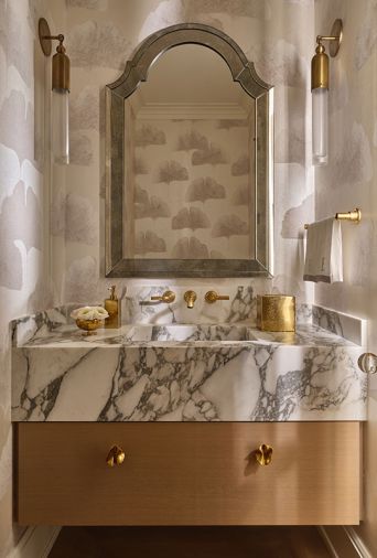 Guests are greeted with a stellar jewel box powder room whose dreamy aspects include a Calacatta Viola marble sink by Lambert Stoneworks, with ceruse finish cabinet by O.B. Williams and Morgans Fine Finishes. Guests are greeted with a stellar jewel box powder room whose dreamy aspects include a Calacatta Viola marble sink by Lambert Stoneworks, with ceruse finish cabinet by O.B. Williams and Morgans Fine Finishes.