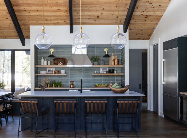 In the kitchen, the wooden shelving and cabinetry pops on “Chloe in Green” tile from Bedrosians. Caesarstone raw concrete counters from Imagine Stoneworks and stools from Denver Modern round out the room. In the kitchen, the wooden shelving and cabinetry pops on “Chloe in Green” tile from Bedrosians. Caesarstone raw concrete counters from Imagine Stoneworks and stools from Denver Modern round out the room.