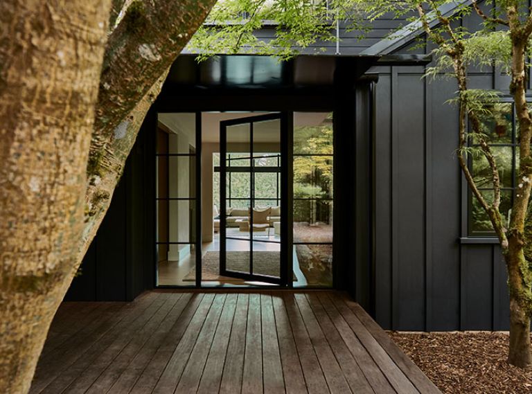 The modern aesthetic is set with board and batten exterior siding painted in Benjamin Moore “Onyx.” The black-framed windows and door by Marvin were sourced from Cherry Creek Windows & Doors. The modern aesthetic is set with board and batten exterior siding painted in Benjamin Moore “Onyx.” The black-framed windows and door by Marvin were sourced from Cherry Creek Windows & Doors.